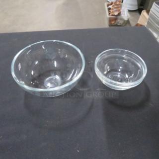 Assorted clear glass ramekins in two sizes; gently used, smooth glass finish, ideal for baking or serving.