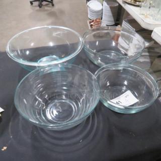 Assorted clear glass mixing bowls in various sizes, in good condition. Auction tag labeled "4XBID" is visible.