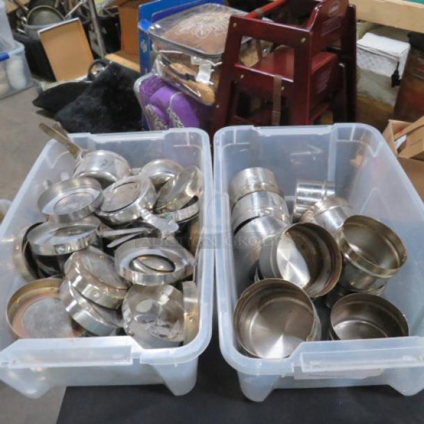 One lot of stainless steel chafer holders in two clear bins, used condition, varying sizes and designs.