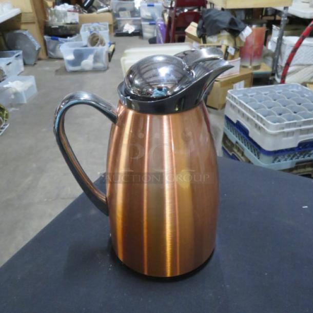 Copper color insulated coffee server, sleek design, with chrome lid and handle, in excellent condition.