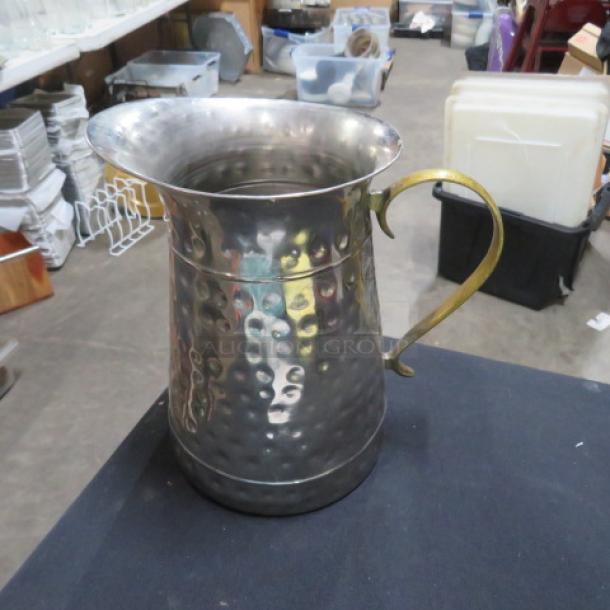 Stainless steel hammered water pitcher with brass handle, excellent condition. Perfect for collectors or functional use.