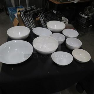 Assorted size white bowls set, ten pieces, in varying dimensions. Excellent condition. Suitable for various uses.