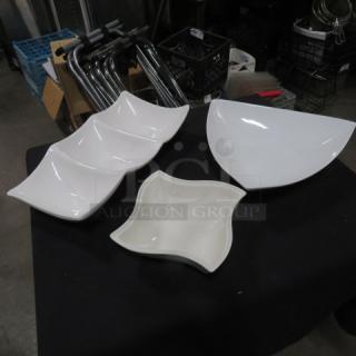 Assorted ceramic serving dishes in various shapes on a black surface; pristine condition, perfect for entertaining.