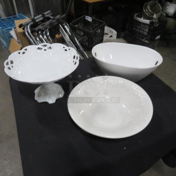 Assorted serving dish set with three pieces: a footed lace-edge platter, an oval bowl, and a round embossed bowl.