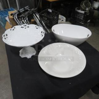 Assorted serving dish set with three pieces: a footed lace-edge platter, an oval bowl, and a round embossed bowl.