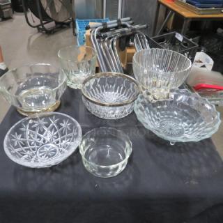 Assorted glassware set, includes various patterned bowls of different sizes, in good condition, displayed on a black cloth.
