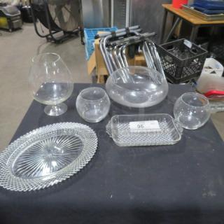 Assorted glassware lot including a goblet, bowls, circular vase, and platters on display. Item number 96 visible.
