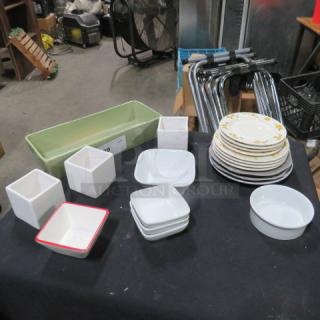 Assorted dishware lot including plates, bowls, and pots. Features floral patterns and solid colors. Good condition.