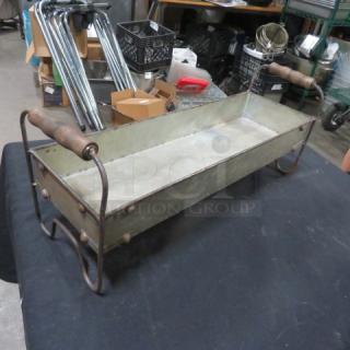 Rectangular decorative tin holder with wooden handles, rustic finish. Sturdy metal frame, ideal for storage or display.