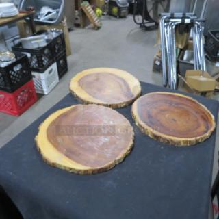 Three wooden decorative holders made from natural wood slices, showcasing unique grain patterns and rustic edges.