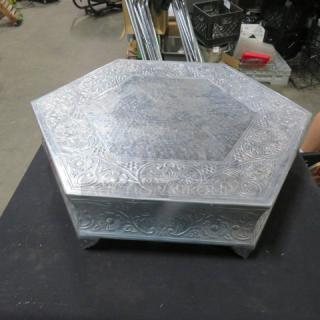 Hexagonal 18x21x6 silver decorative stand with ornate floral engravings, in good condition, ideal for display or serving.