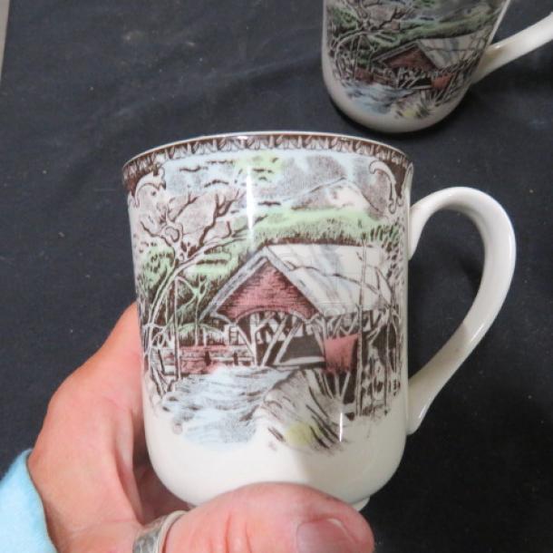 Collectible coffee cup with rustic cabin scene, intricate detailing, excellent condition. Model 4XBID.