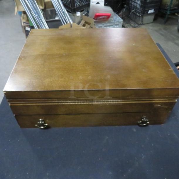 Wooden flatware box with one drawer, featuring vintage flatware. Sturdy, polished finish with metal handle accents.
