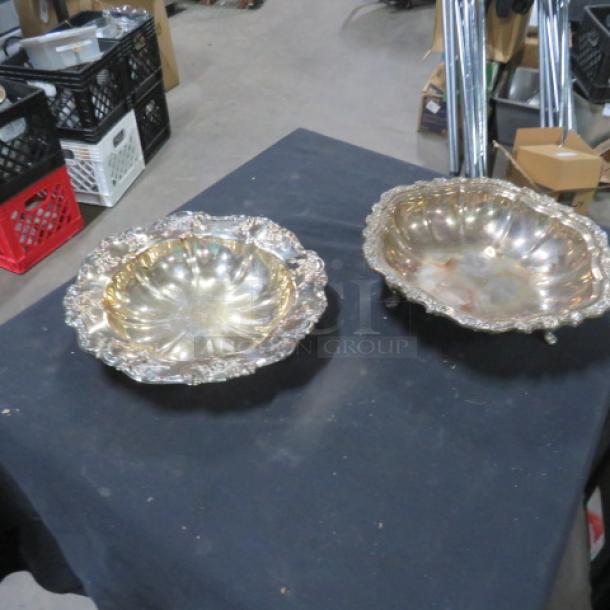 11-inch round silver plate bowls with ornate edges, set of two; reflective surface shows mild tarnish, no visible markings.