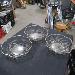 Silver wire baskets, set of three, intricate floral design, used condition, metal construction, displayed on black surface.