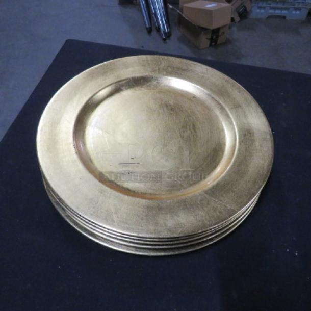 Gold charger plates, set of 5, round, metallic finish, good condition, ideal for elegant table settings.