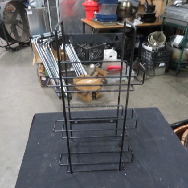 Black wire holder, three-tiered, in good condition. Suitable for organizing, with sturdy metal construction.