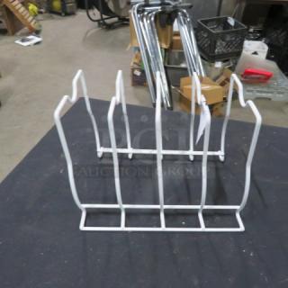 White metal plate holder, six slots, good condition. Ideal for organizing plates. No visible markings or tags.