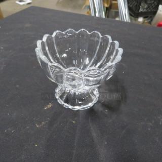 Clear glass footed sundae dish with scalloped edge and decorative patterns, model 10XBID, in excellent condition.