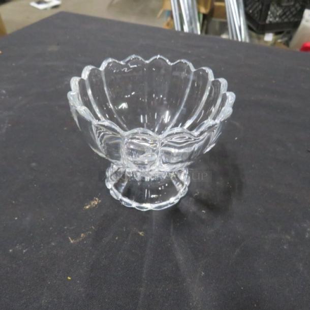 Clear footed sundae dish with scalloped edges and ornate design, glass material, excellent condition, item 10XBID.