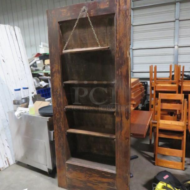 Vintage multi-use door with custom shelving, 36x83.5 inches, for liquor display. Rustic wood finish, good condition.