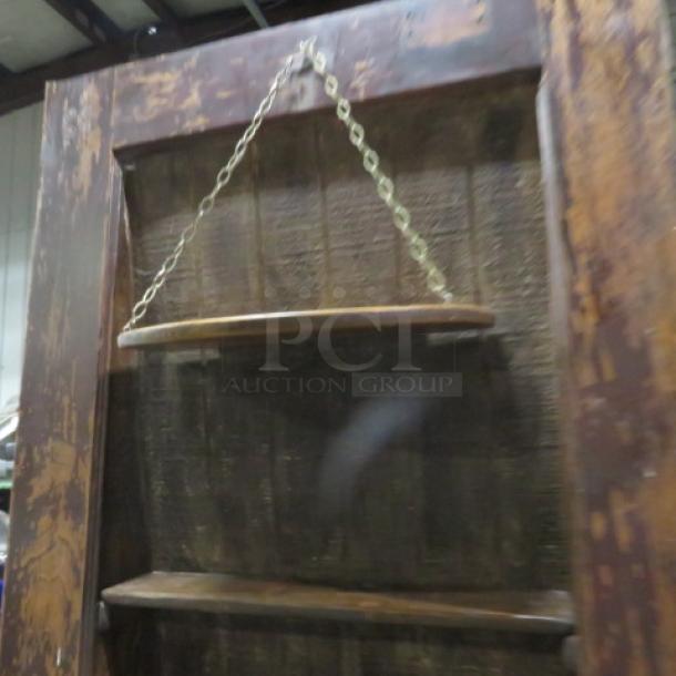 Vintage multi-use door with custom shelving for liquor display, measuring 36x83.5 inches, rustic condition.