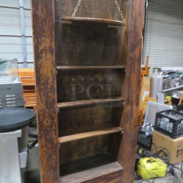 Vintage wooden door with custom shelving, used as a liquor holder. Measures 36x83.5 inches. Rustic condition.