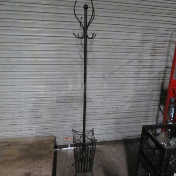 Black metal coat rack with multiple hooks and a basket base, in good condition. Minimalist design for versatile use.