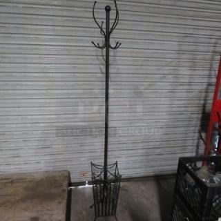 Black metal coat rack with multiple hooks and a basket base, in good condition. Minimalist design for versatile use.
