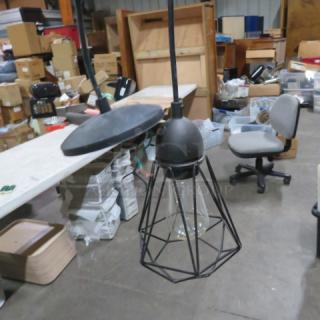 Industrial look pendant light with metal cage design, clear glass shade, black finish, model 5XBID, in good condition.