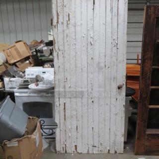 Vintage decorative door, 41x90 inches, distressed white paint, vertical panel design, rustic condition.