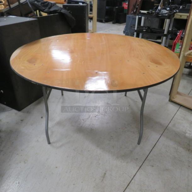 60-inch round wooden folding table, 60x60x30 inches. Polished surface, metal legs; gently used condition.