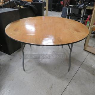 60-inch round wooden folding table, 60x60x30 inches. Polished surface, metal legs; gently used condition.