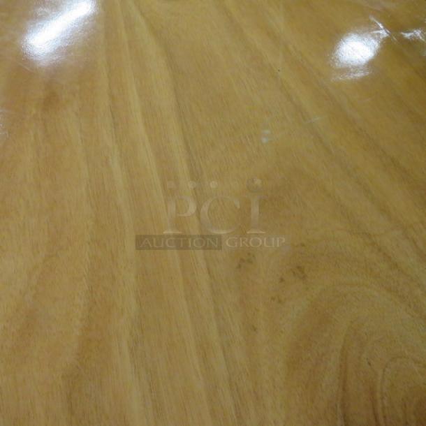 60-inch round wooden folding table, dimensions 60x60x30 inches. Polished surface, sturdy condition, ideal for events.