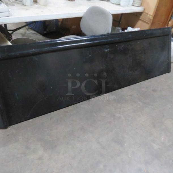 Black painted wooden portable bar top, measuring 102x27 inches. Slight wear visible, suitable for versatile use.