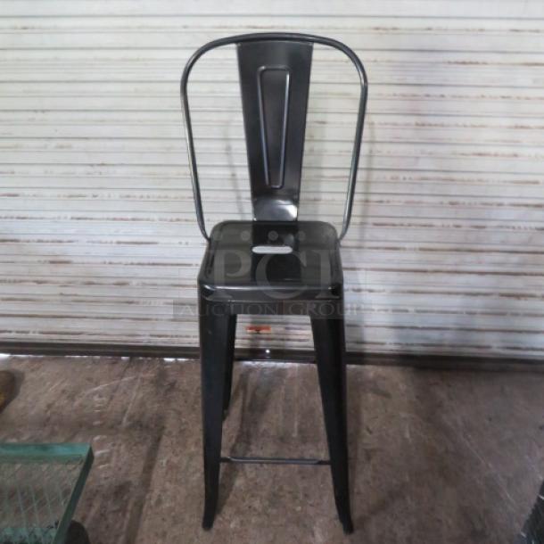 Black metal industrial bar height chair, new, assembly required. Features a minimalist design and durable construction.