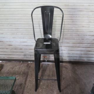 Black metal bar-height chair with an industrial look. New, assembly required. Features a tall backrest and footrest.