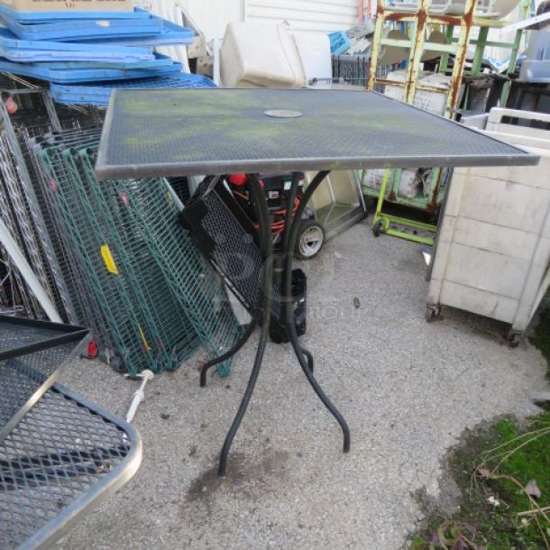 Black metal bar height patio table, 36x36x42 inches, square top with umbrella hole, sturdy legs, outdoor use.
