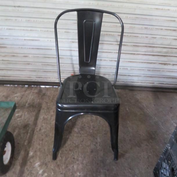 Black metal industrial look chair, sturdy design, vintage style, minor wear, 2XBID branding possibly on seat.