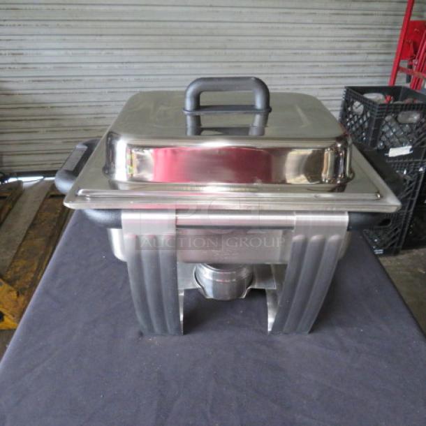One NEW Vollrath 4.1 Quart Dakota Half Size Chafer Set, Model 99870. Stainless steel with black handles, excellent condition.
