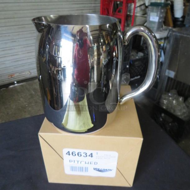 Vollrath stainless steel pitcher, 68oz, model 46634, new condition, reflective finish, on box labeled with model and brand.