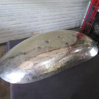 Hammered boat style serving bowl, 29x12 inches, metallic finish, reflective surface, slightly domed design, visible hammer marks.