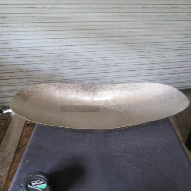 Hammered boat style serving bowl, 29x12 inches. Features a textured design, metallic finish, excellent condition.