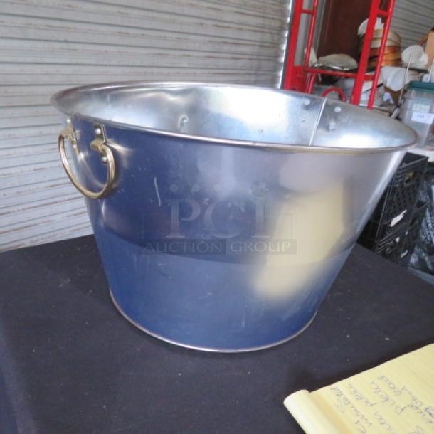 One 16x10 metal beverage tub with gold handles, in good condition. Ideal for entertaining or display.