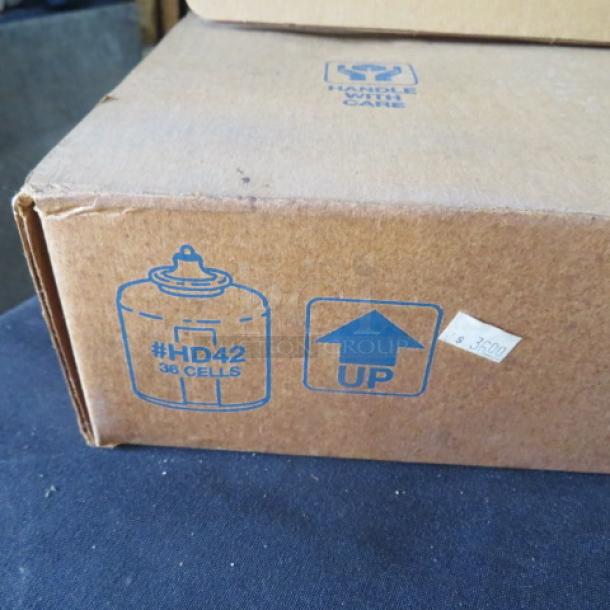 New case of 36 Hollowick HD42 liquid candles, 42-hour duration. Box shows item number and "UP" handling instructions.