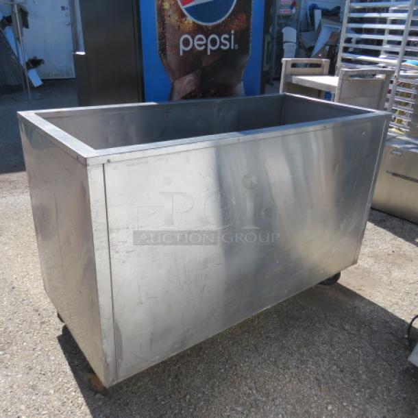 Stainless steel ICE DOWN beverage tub on casters, dimensions 52.5x24x35, slightly worn, suitable for events or catering.