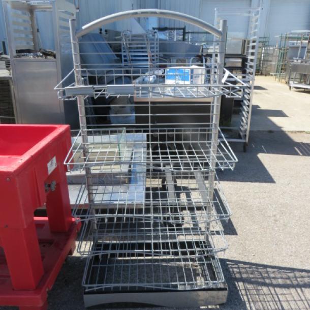 Metal shelving system with 5 wire shelves on casters. Measures 29x17x59 inches. Features a curved top handle.