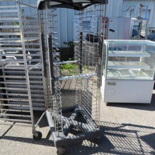 Rubbermaid Speed Rack on casters, 23x27x69 inches, metal frame, used condition, designed for efficient storage and transport.
