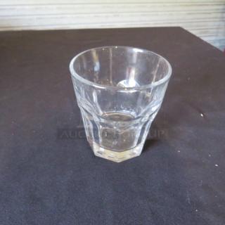 Clear rocks glass, 10XBID, featuring a faceted design. Appears in good condition with no visible chips or scratches.