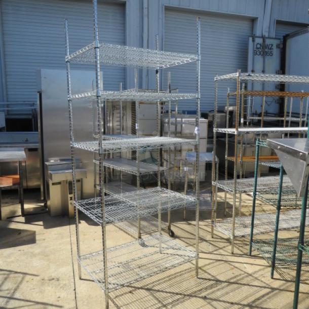 Metro five-shelf unit, 36x24x86 inches, metal wire construction, used condition, sturdy and spacious for storage.